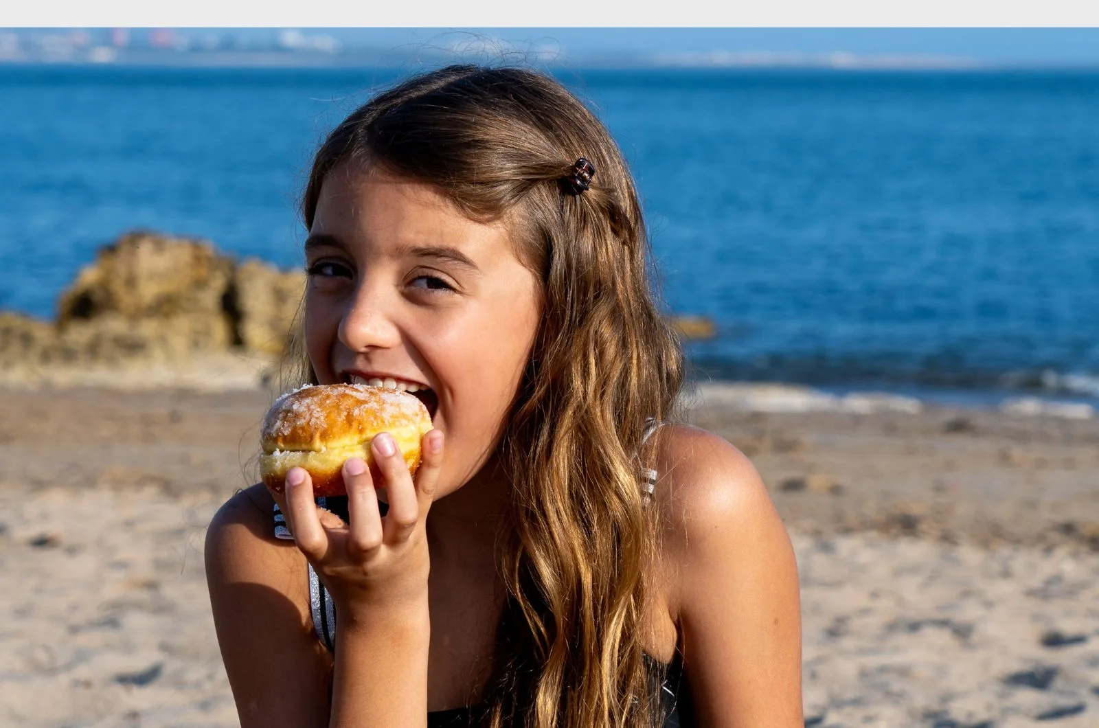 A brasileira Maria Luiza Lisboa, de 9 anos, ama a "bolinha": “Meus sabores preferidos são de creme, Nutella e Kinder Ovo”. Crédito: Renato Velasco